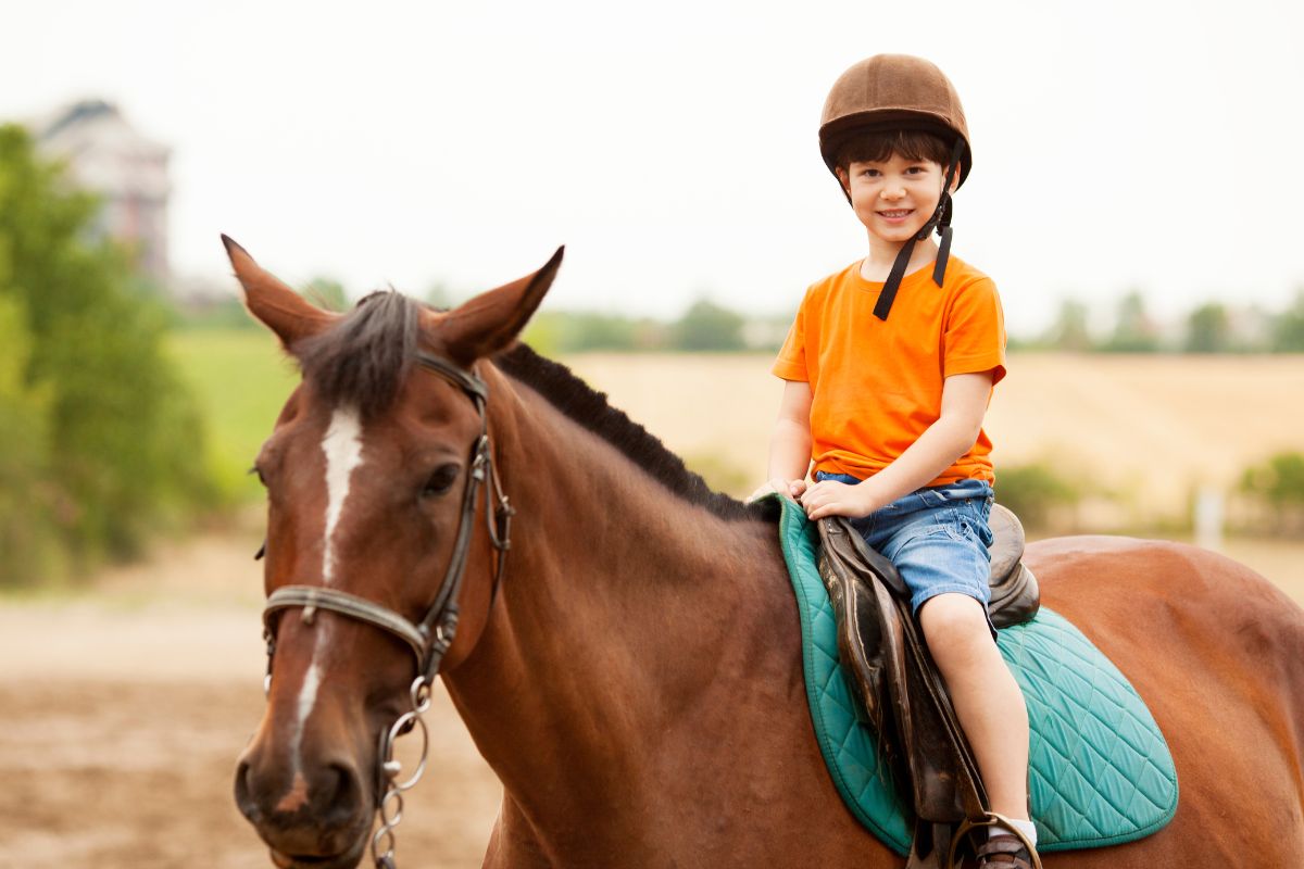 Child riding horse outdoors