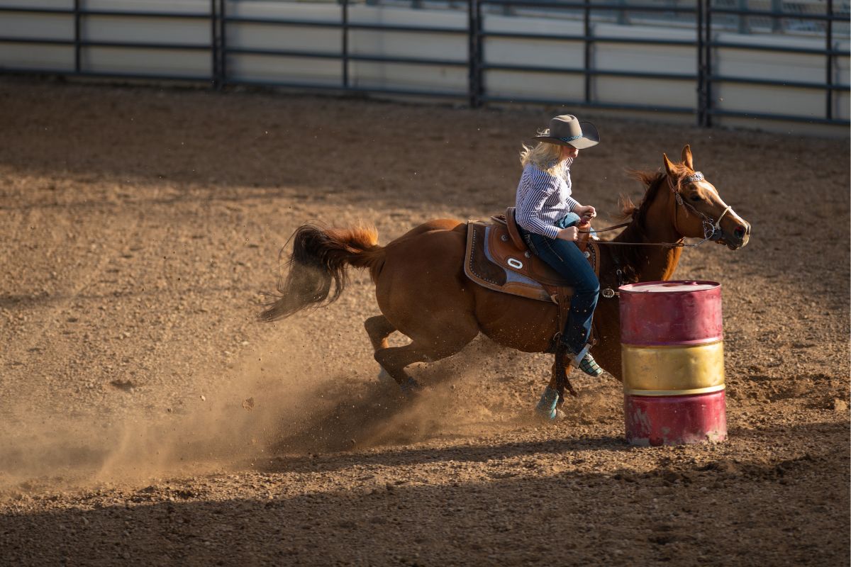 Young cowgirl barrel racing rodeo